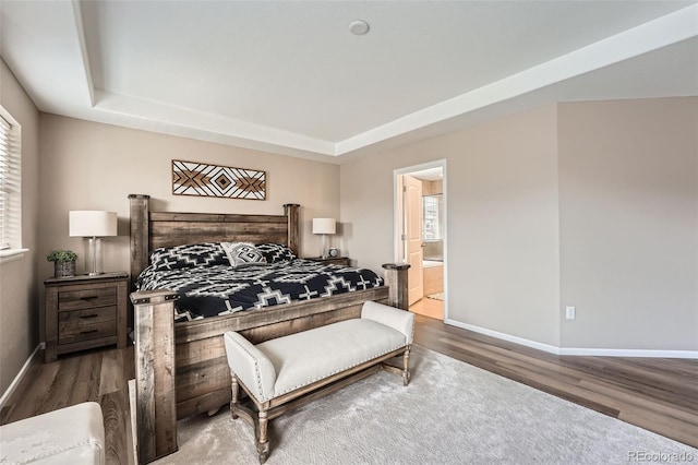 26731 E Hinsdale Pl, Aurora, CO 80016 - bedroom with baseboards, ensuite bath, wood finished floors, and a tray ceiling