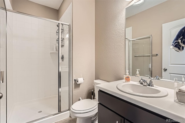 26731 E Hinsdale Pl, Aurora, CO 80016 - full bathroom featuring vanity, a textured wall, a stall shower, and toilet