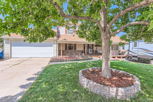 view of front of property featuring a porch, a garage, and a front yard