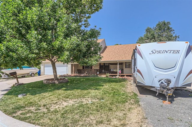 view of front of house with a porch, a garage, and a front yard