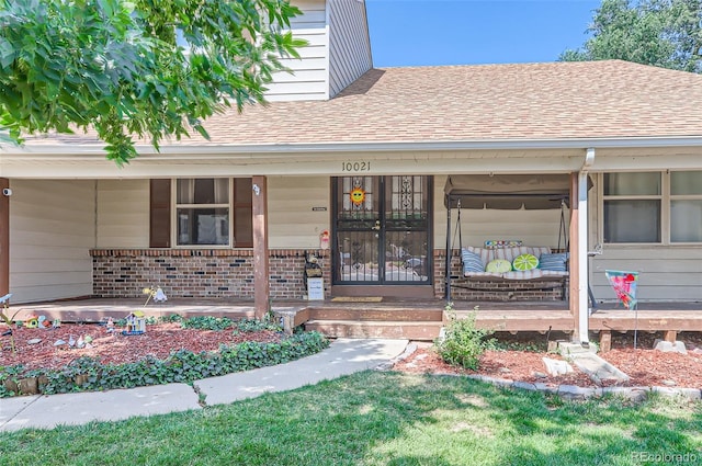 view of exterior entry with covered porch