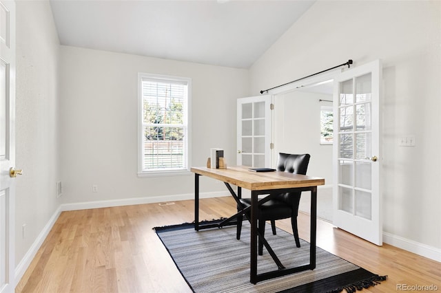 office area with lofted ceiling, french doors, light wood-type flooring, and baseboards