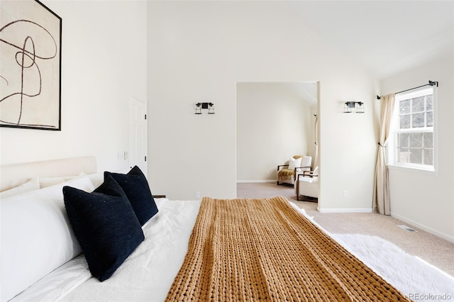 bedroom with high vaulted ceiling, baseboards, visible vents, and light carpet