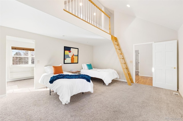 carpeted bedroom featuring visible vents, recessed lighting, high vaulted ceiling, and baseboards