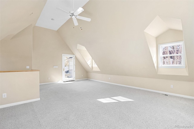 bonus room featuring plenty of natural light, a ceiling fan, and lofted ceiling