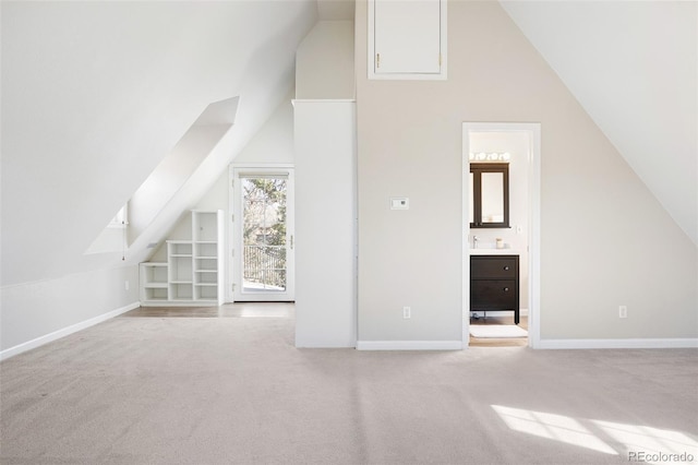 additional living space featuring lofted ceiling, carpet flooring, and baseboards