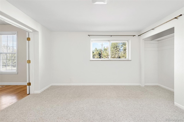 unfurnished bedroom with a closet, baseboards, and carpet floors