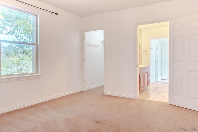 4368 Benton St, Denver, CO 80212 - unfurnished bedroom featuring a spacious closet, light carpet, and a closet