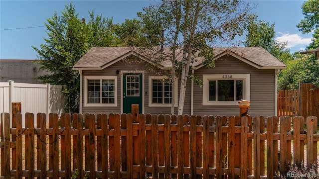 4368 Benton St, Denver, CO 80212 - view of front of property featuring a fenced front yard and a shingled roof