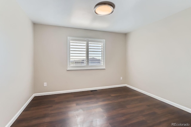 31142 County Road 18, Keenesburg, CO 80643 - spare room featuring visible vents, baseboards, and dark wood-style floors