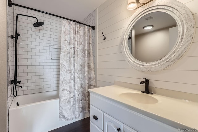 31142 County Road 18, Keenesburg, CO 80643 - bathroom featuring visible vents, wooden walls, vanity, and shower / tub combo with curtain