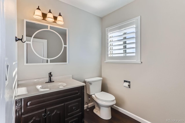 31142 County Road 18, Keenesburg, CO 80643 - half bath with toilet, baseboards, vanity, and wood finished floors