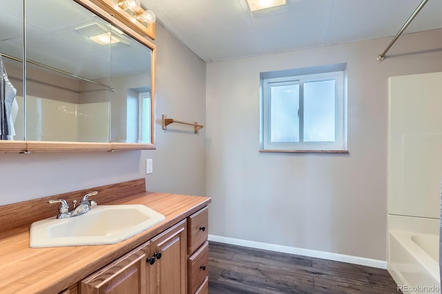 31142 County Road 18, Keenesburg, CO 80643 - bathroom featuring vanity, wood finished floors, and baseboards