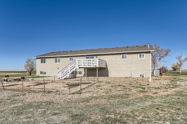 31142 County Road 18, Keenesburg, CO 80643 - back of property featuring central air condition unit, stairs, a wooden deck, and fence