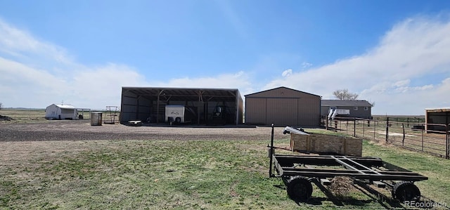 31142 County Road 18, Keenesburg, CO 80643 - view of pole building with fence, a carport, and a lawn