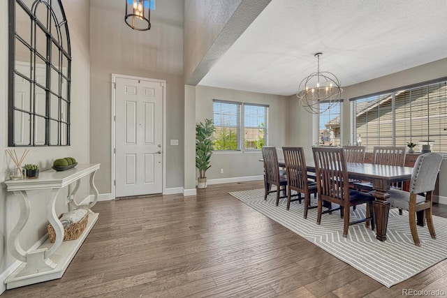 6738 Esmeralda Dr, Castle Rock, CO 80108 - dining space featuring a chandelier, baseboards, and wood finished floors
