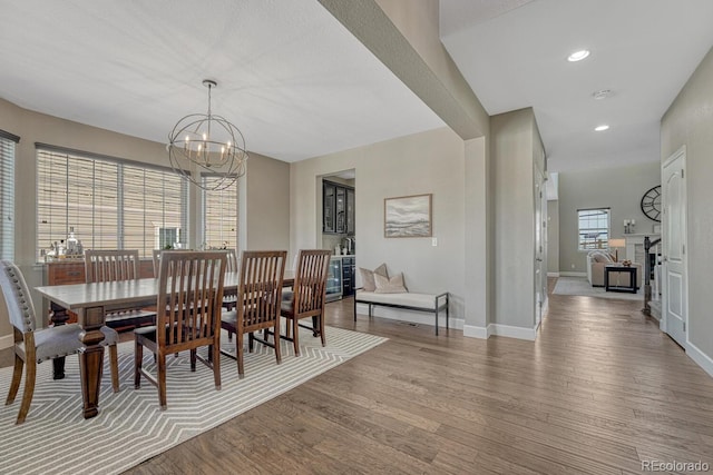 6738 Esmeralda Dr, Castle Rock, CO 80108 - dining room featuring light wood-type flooring, a chandelier, baseboards, and recessed lighting