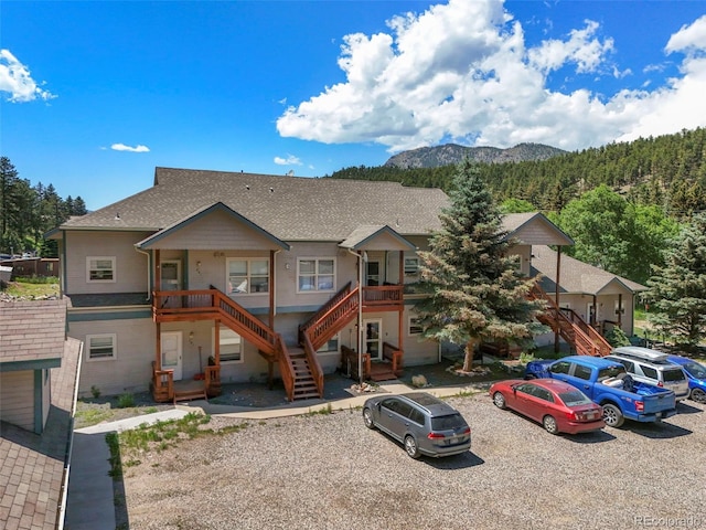 5720 County Road 64 # A102, Bailey, CO 80421 - view of property with stairs, a mountain view, and a shingled roof