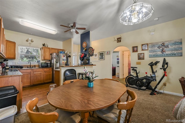 5720 County Road 64 # A102, Bailey, CO 80421 - carpeted dining area featuring a ceiling fan, arched walkways, and a chandelier