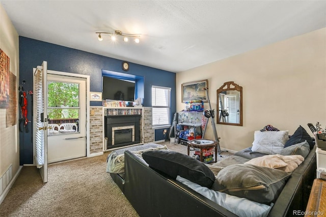 5720 County Road 64 # A102, Bailey, CO 80421 - carpeted living room with a fireplace and baseboards