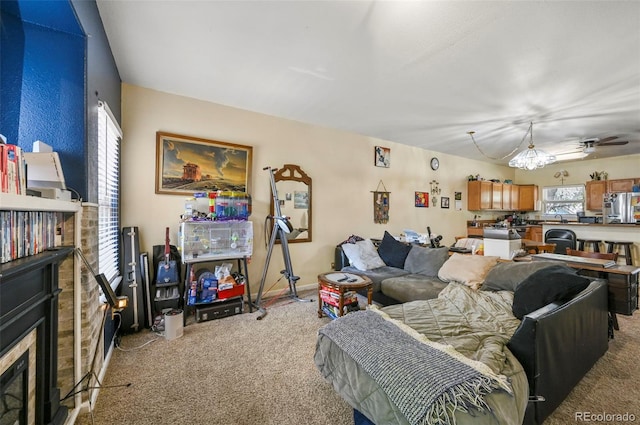 5720 County Road 64 # A102, Bailey, CO 80421 - living room featuring light carpet, a ceiling fan, and a glass covered fireplace