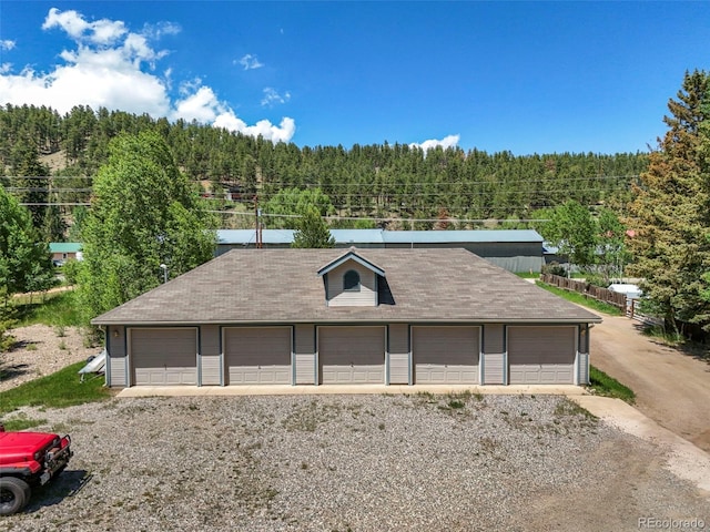 5720 County Road 64 # A102, Bailey, CO 80421 - detached garage featuring a view of trees