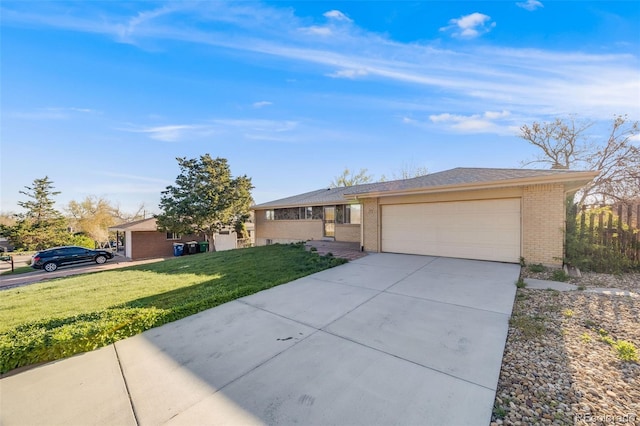 772 Urban Ct, Lakewood, CO 80401 - ranch-style house featuring concrete driveway, an attached garage, a front yard, and brick siding