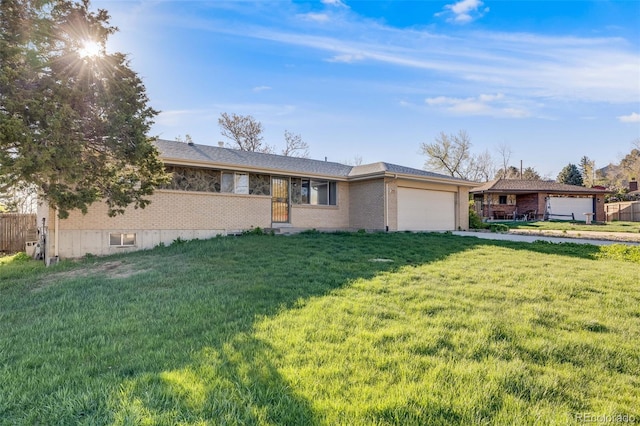 772 Urban Ct, Lakewood, CO 80401 - ranch-style house with concrete driveway, brick siding, a front yard, and a garage