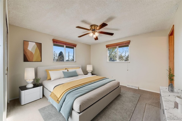 772 Urban Ct, Lakewood, CO 80401 - bedroom with carpet flooring, a textured ceiling, visible vents, and multiple windows