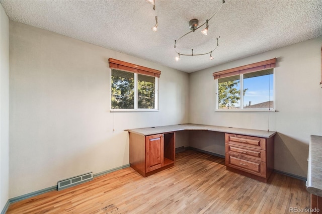 772 Urban Ct, Lakewood, CO 80401 - unfurnished office featuring built in study area, visible vents, a wealth of natural light, and light wood-type flooring