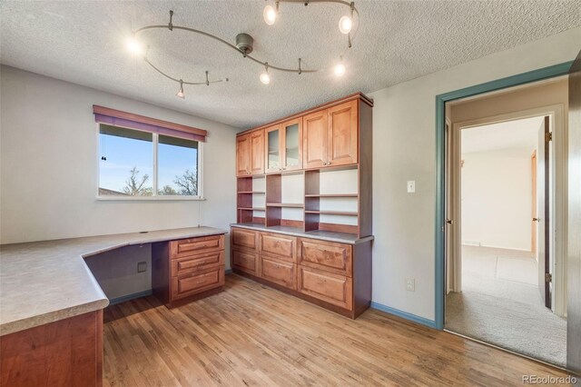 772 Urban Ct, Lakewood, CO 80401 - unfurnished office featuring built in study area, a textured ceiling, and light wood finished floors