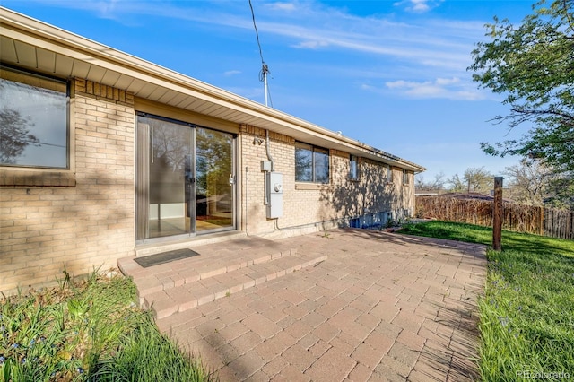 772 Urban Ct, Lakewood, CO 80401 - rear view of house with fence, a patio area, and brick siding