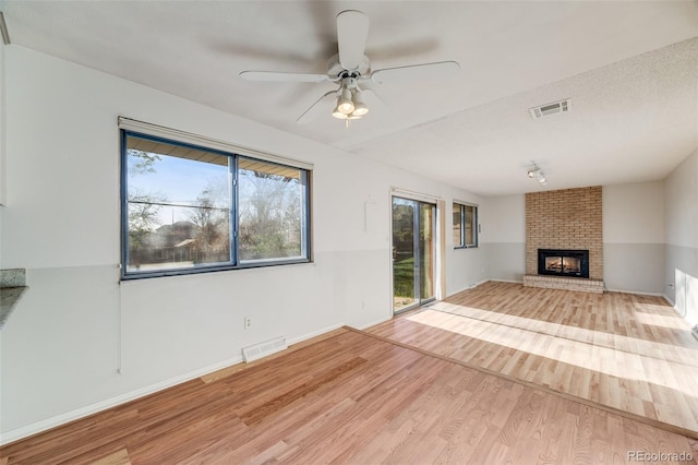 772 Urban Ct, Lakewood, CO 80401 - unfurnished living room with a ceiling fan, visible vents, and wood finished floors