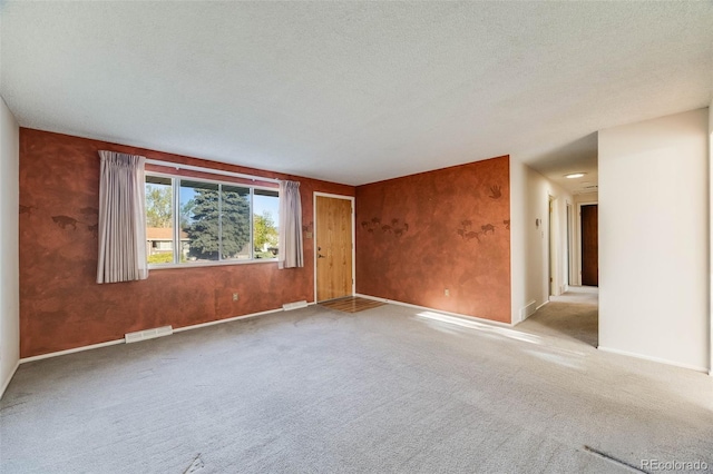 772 Urban Ct, Lakewood, CO 80401 - spare room with carpet floors, a textured ceiling, baseboards, and visible vents