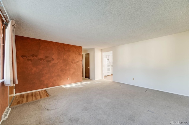 772 Urban Ct, Lakewood, CO 80401 - spare room with baseboards, carpet, a textured ceiling, and visible vents