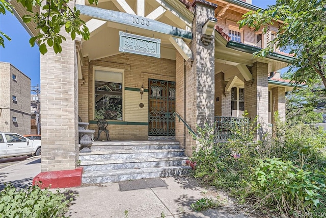 view of exterior entry with a porch