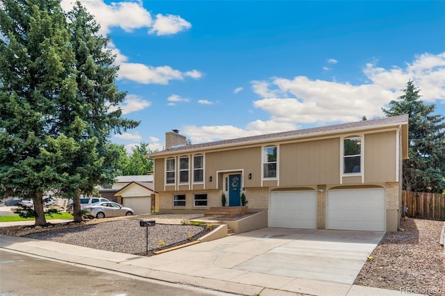 4451 Ranch Cir, Colorado Springs, CO 80918 - split foyer home featuring brick siding, a chimney, a garage, and concrete driveway