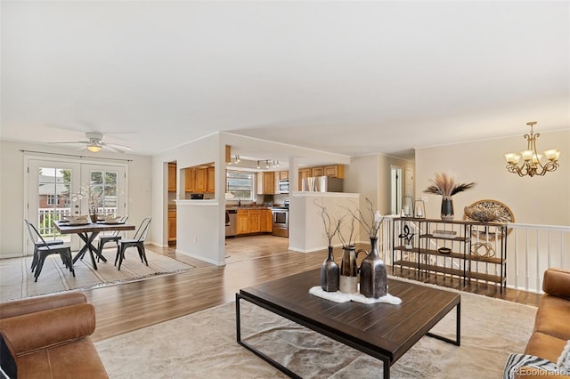 4451 Ranch Cir, Colorado Springs, CO 80918 - living room featuring a chandelier, light wood-type flooring, and ceiling fan