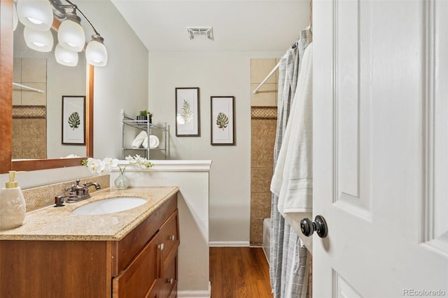 4451 Ranch Cir, Colorado Springs, CO 80918 - bathroom featuring vanity, shower / bathtub combination with curtain, and wood finished floors