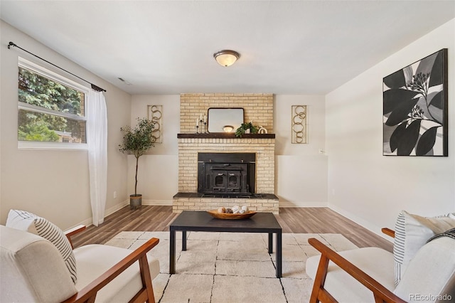 4451 Ranch Cir, Colorado Springs, CO 80918 - living area featuring wood finished floors and a brick fireplace