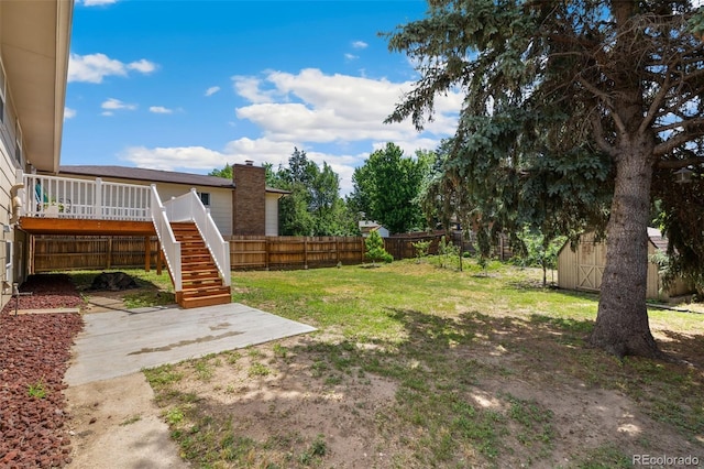 4451 Ranch Cir, Colorado Springs, CO 80918 - fenced backyard with stairs, a shed, a wooden deck, and a patio