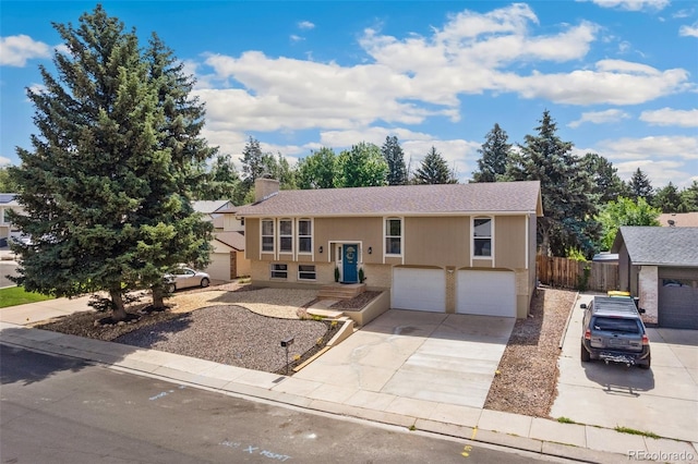4451 Ranch Cir, Colorado Springs, CO 80918 - bi-level home with an attached garage, driveway, a chimney, and roof with shingles