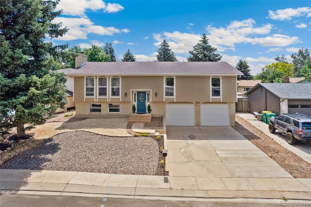 4451 Ranch Cir, Colorado Springs, CO 80918 - split foyer home with a garage, a chimney, concrete driveway, and a shingled roof