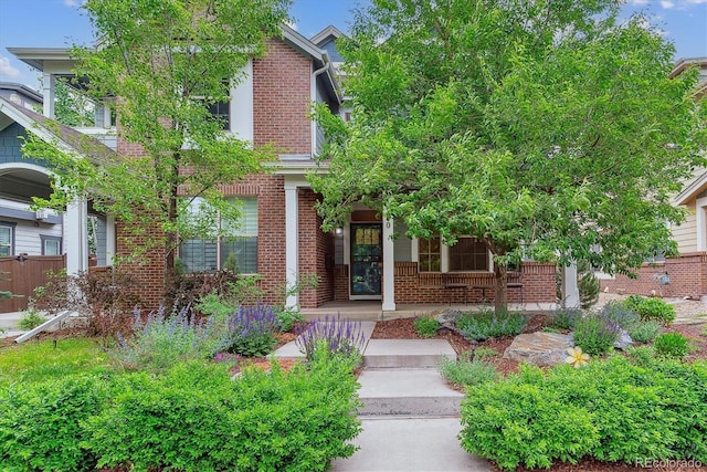 1160 S Sherman St, Denver, CO 80210 - obstructed view of property featuring brick siding and covered porch
