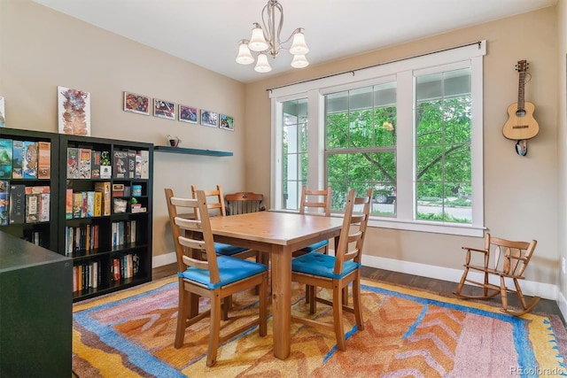 1160 S Sherman St, Denver, CO 80210 - dining room with baseboards, a chandelier, and wood finished floors