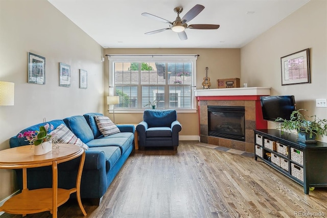 1160 S Sherman St, Denver, CO 80210 - living room with wood finished floors, a tiled fireplace, a ceiling fan, and baseboards