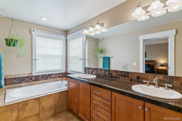 1160 S Sherman St, Denver, CO 80210 - bathroom with double vanity, a garden tub, connected bathroom, and tile patterned floors