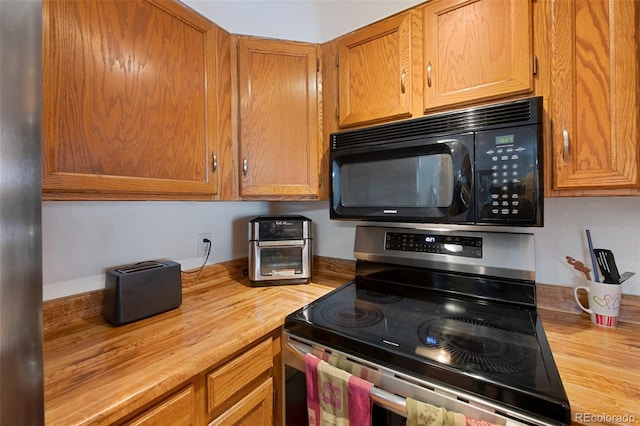 kitchen with electric stove and butcher block counters