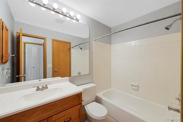 full bathroom featuring vanity, toilet, and tiled shower / bath combo