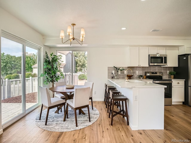 21472 E 46th Ave, Denver, CO 80249 - dining space featuring a chandelier, light wood-type flooring, recessed lighting, and baseboards